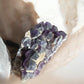 Amethyst raw gemstone with sand on it