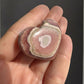Argentine Rhodochrosite heart with vibrant pink and white patterns