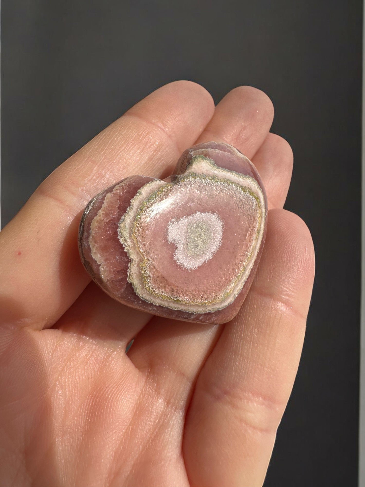 Argentine Rhodochrosite heart with vibrant pink and white patterns