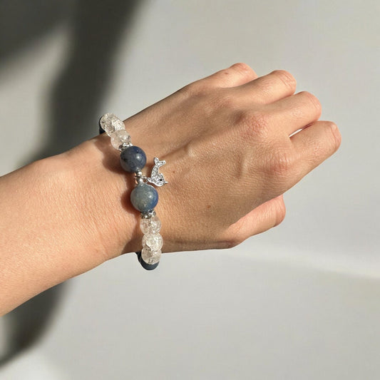 Blue aventurine and crackle clear quartz dolphin crystal bracelet on a hand