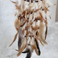 Citrine crystal dreamcatcher close up on feathers