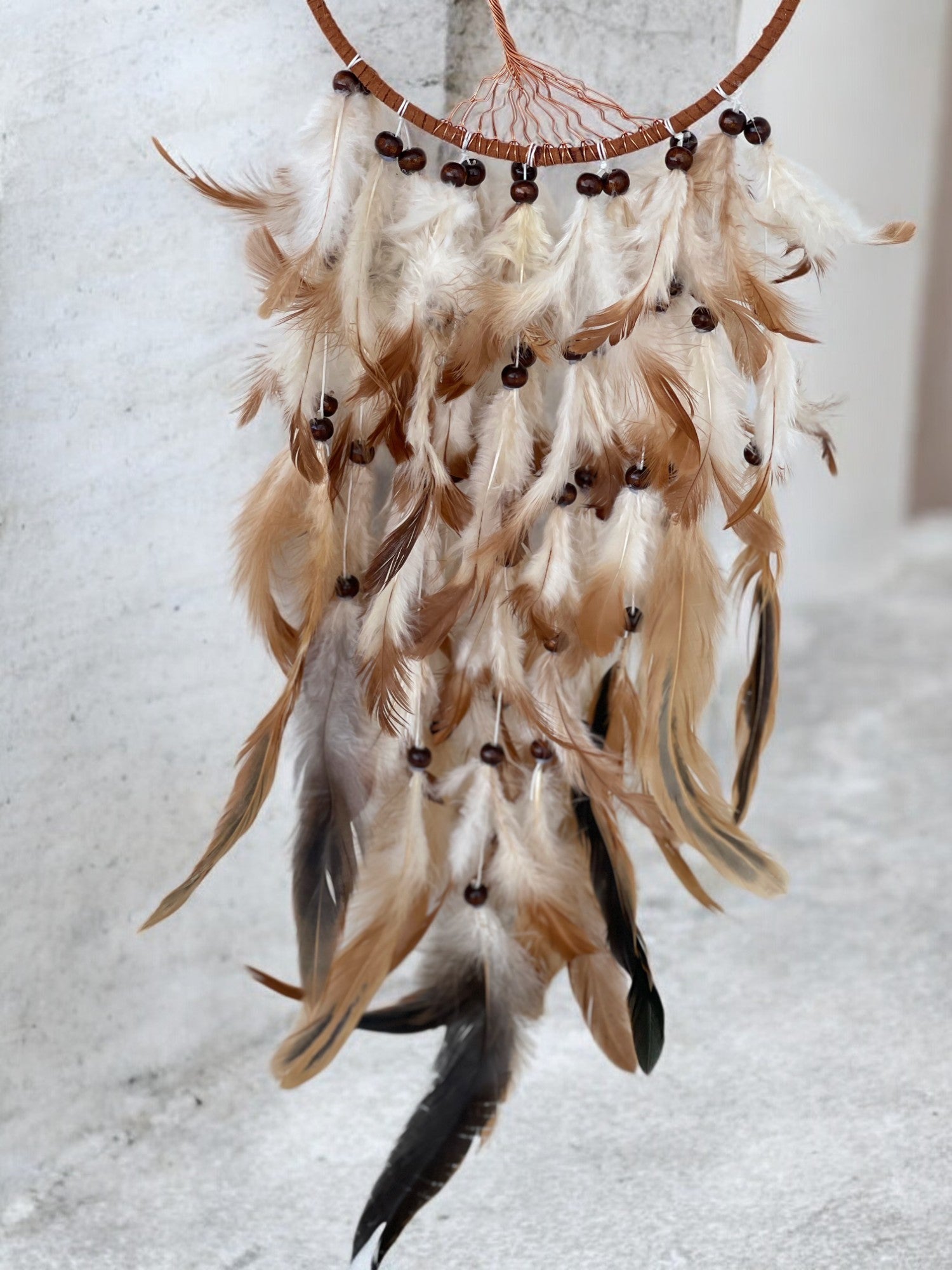 Citrine crystal dreamcatcher close up on feathers