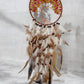 Citrine crystal dreamcatcher hanging on a wall