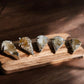 Citrine crystal pendants on a wooden slab