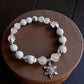 Clear quartz and howlite crystal bracelet with rhinestone snowflake charm