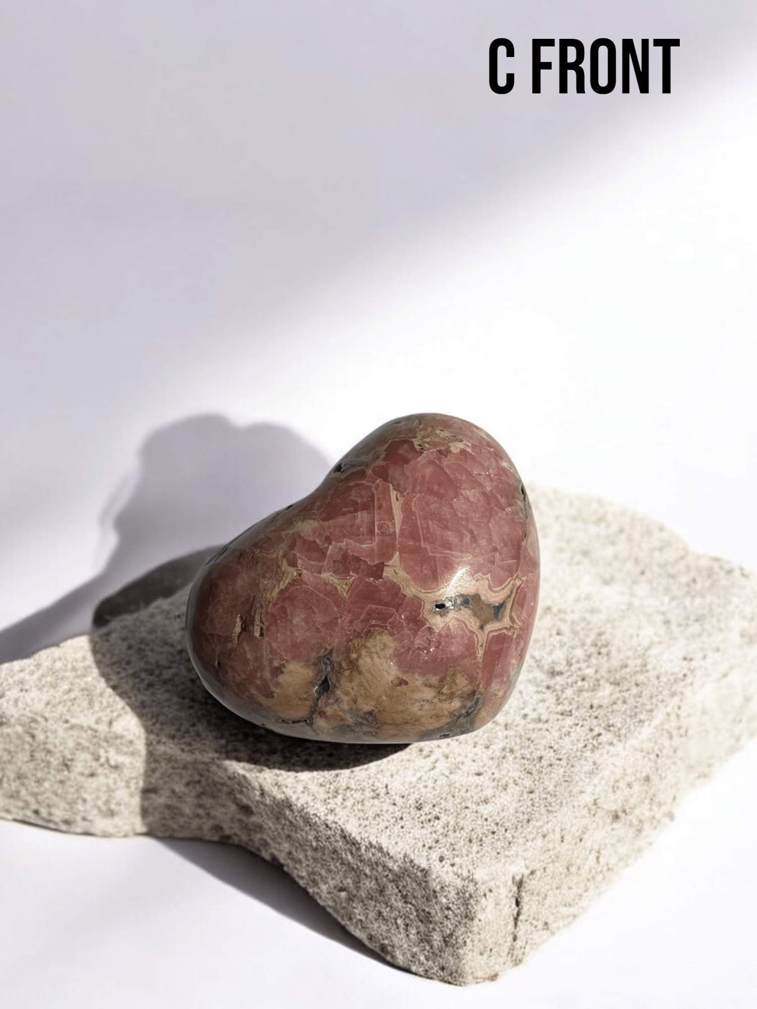 Close-up of a Rhodochrosite heart's intricate color bands