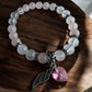 Closer view of Rose Quartz and Clear Quartz Swarovski Heart with wing Crystal Bracelet