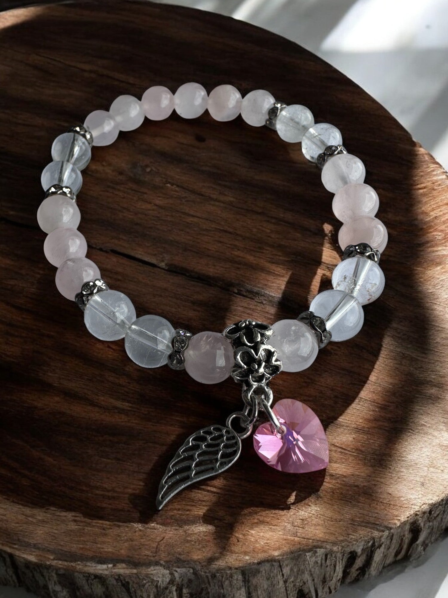Closer view of Rose Quartz and Clear Quartz Swarovski Heart with wing Crystal Bracelet