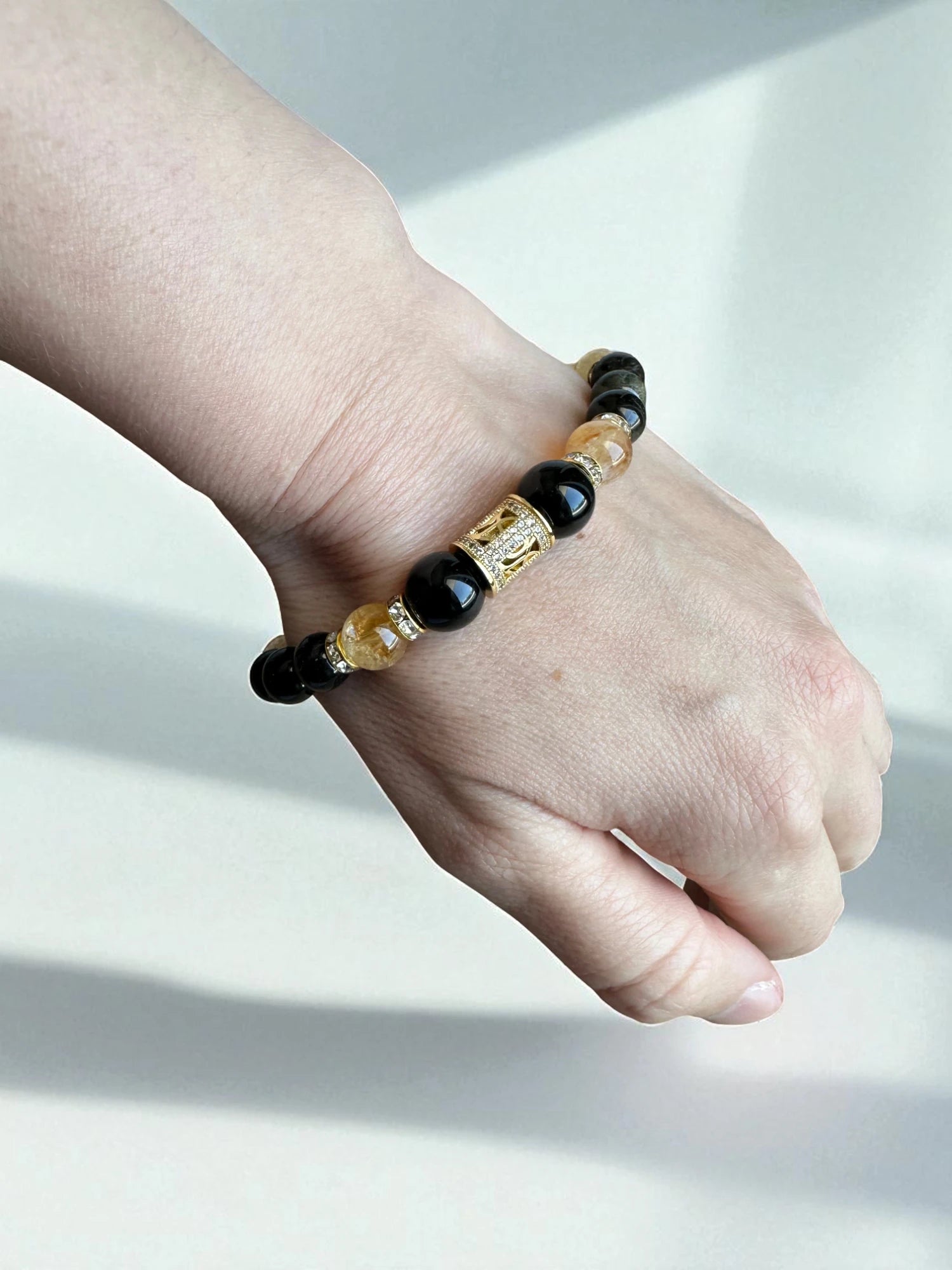Crystal bracelet combining obsidian and citrine for grounding and confidence.