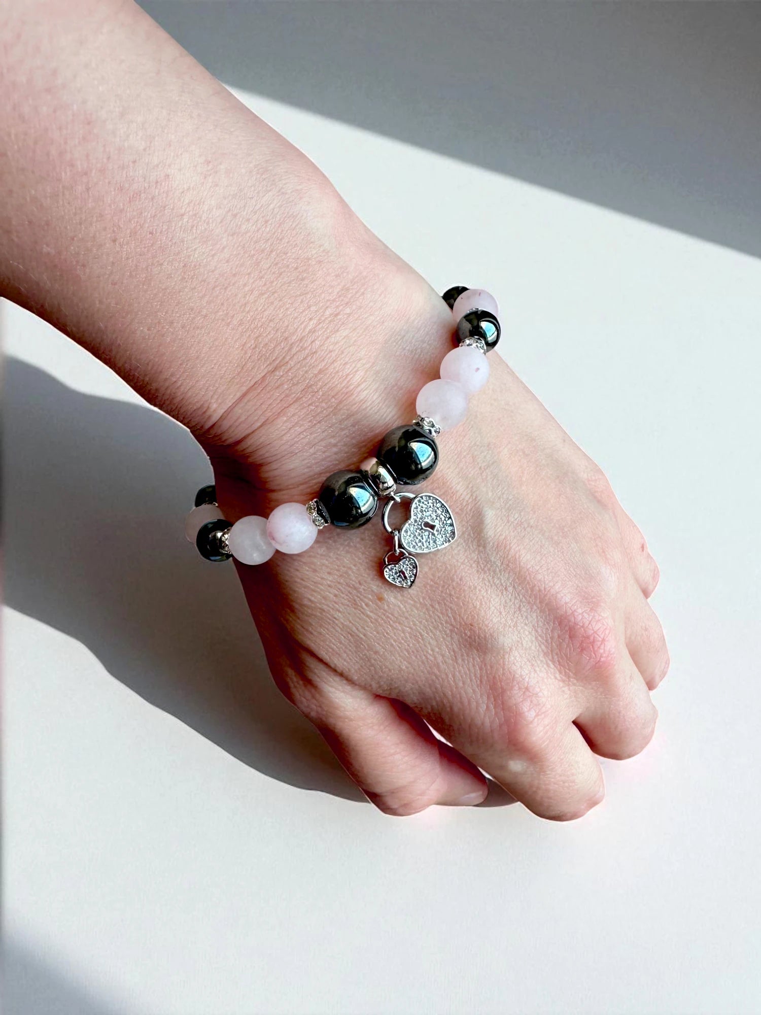 Crystal bracelet combining rose quartz and hematite for balance and grounding