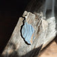 Druzy agate leaf crystal pendant on wood