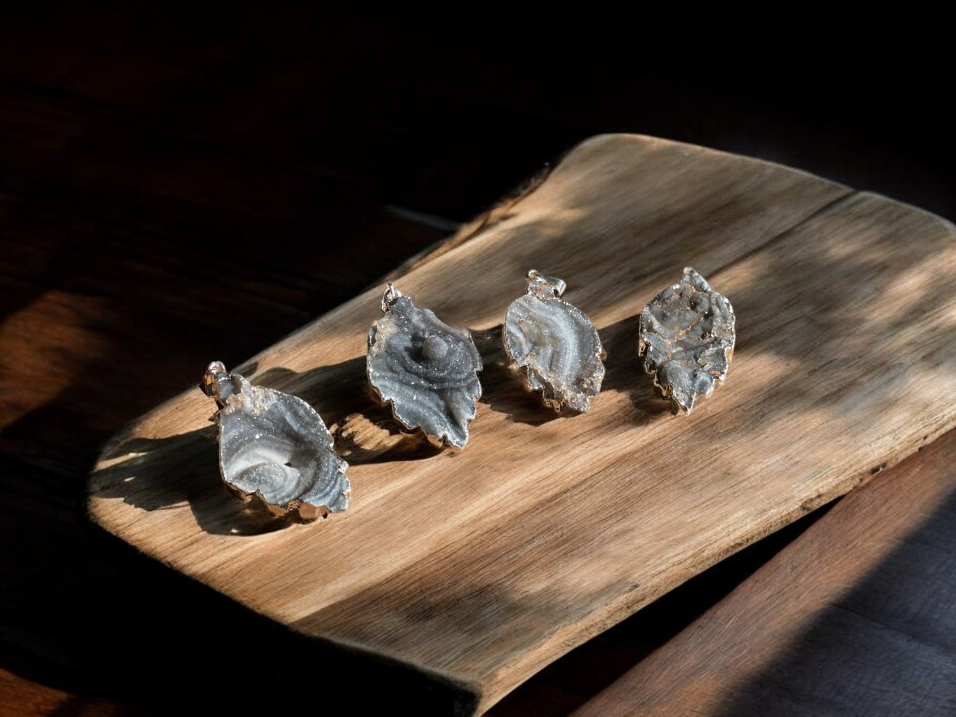 Druzy agate leaf crystal pendants on a slab