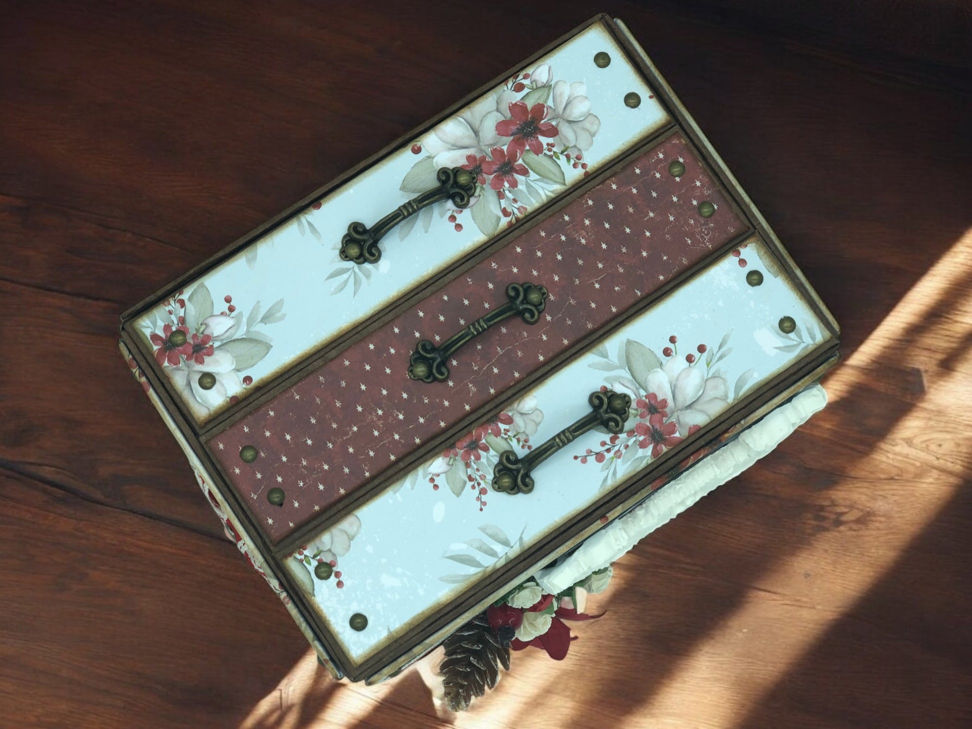 Flat lay of Christmas shabby chic photo box album with vintage papers, ribbons and lace—handmade photo organiser chest for holiday memories.