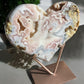 Giant pink amethyst crystal heart on a table