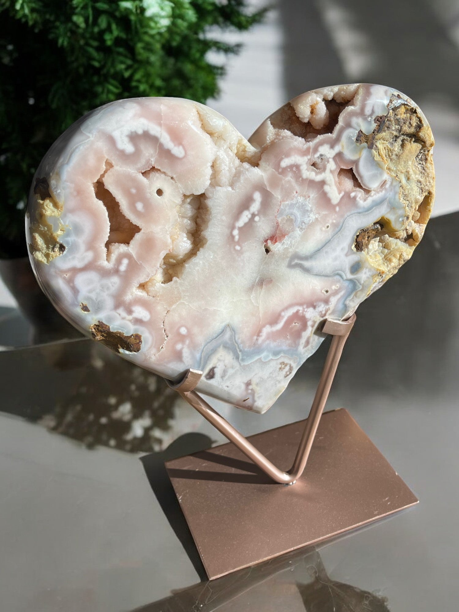 Giant pink amethyst crystal heart on a table