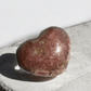Hand-carved Rhodochrosite heart with unique patterns