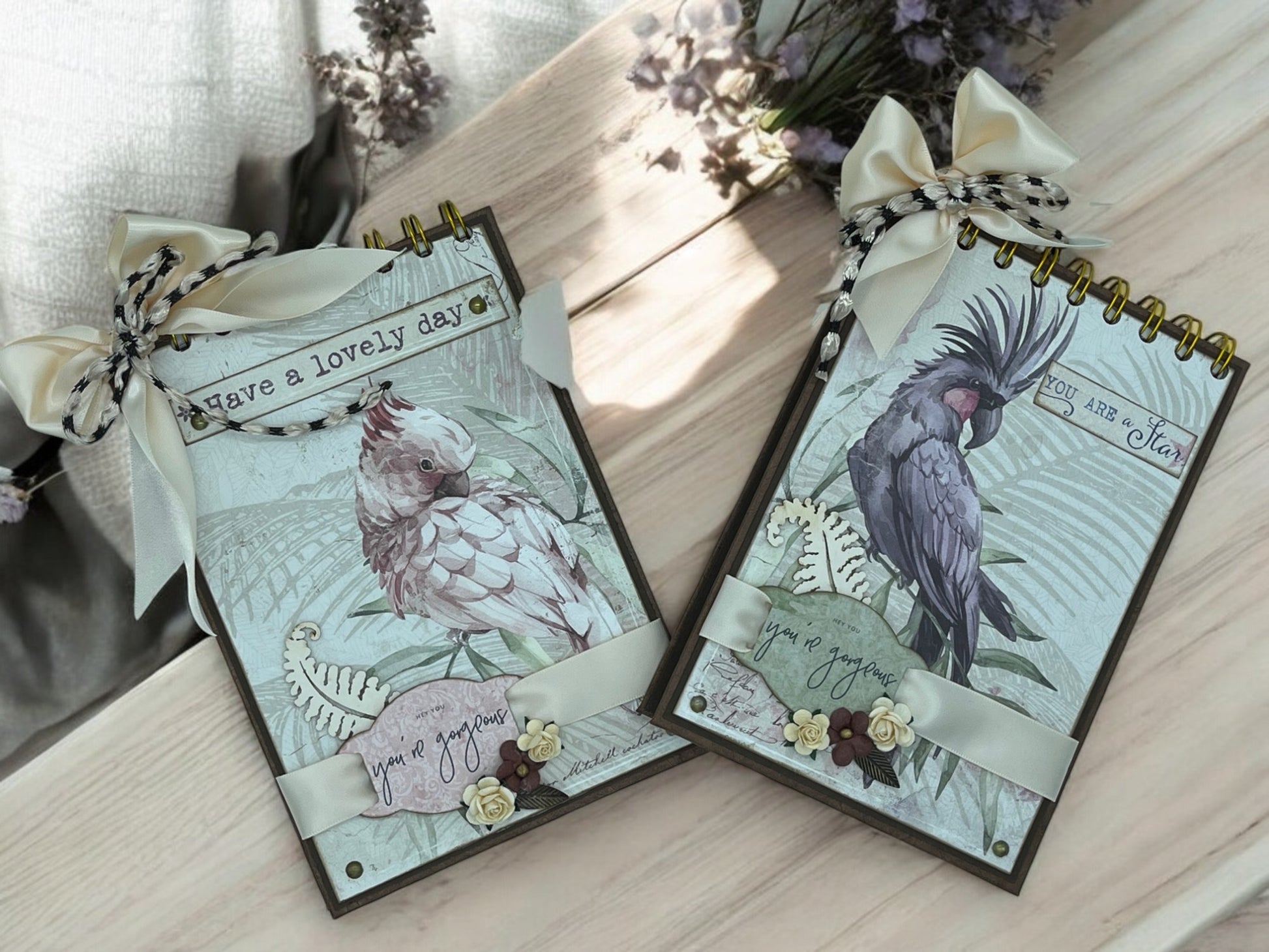 Handmade A6 cockatoo spiral notebook with 40 white pages, golden spiral top binding and removable bow—customisable shabby chic journal in purple and pink.