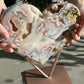 Hands holding pink amethyst crystal heart