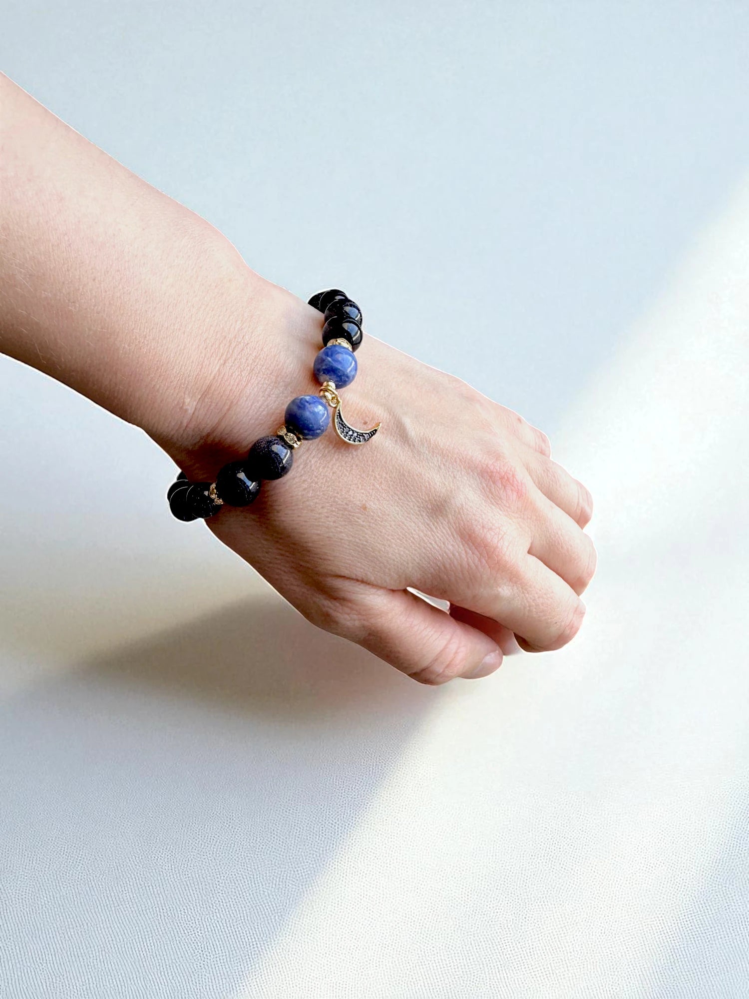 Healing bracelet combining sodalite and blue goldstone for balance and protection.