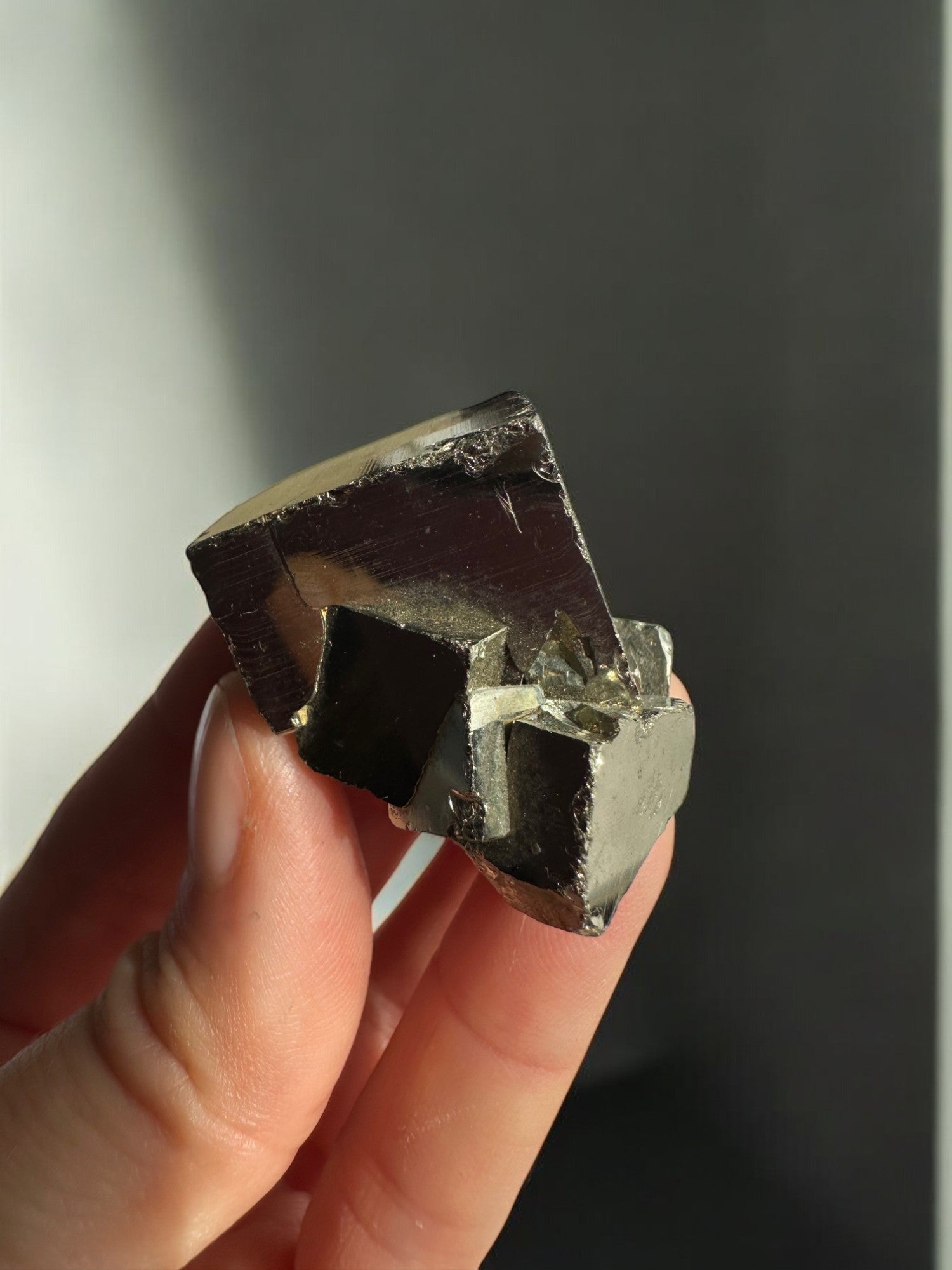 Holding a tiny pyrite cube in my hand
