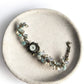 Larimar, Pearl, and Clear Quartz Custom Watch on a plate