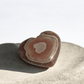 Pink Rhodochrosite heart carved into a crystal shape