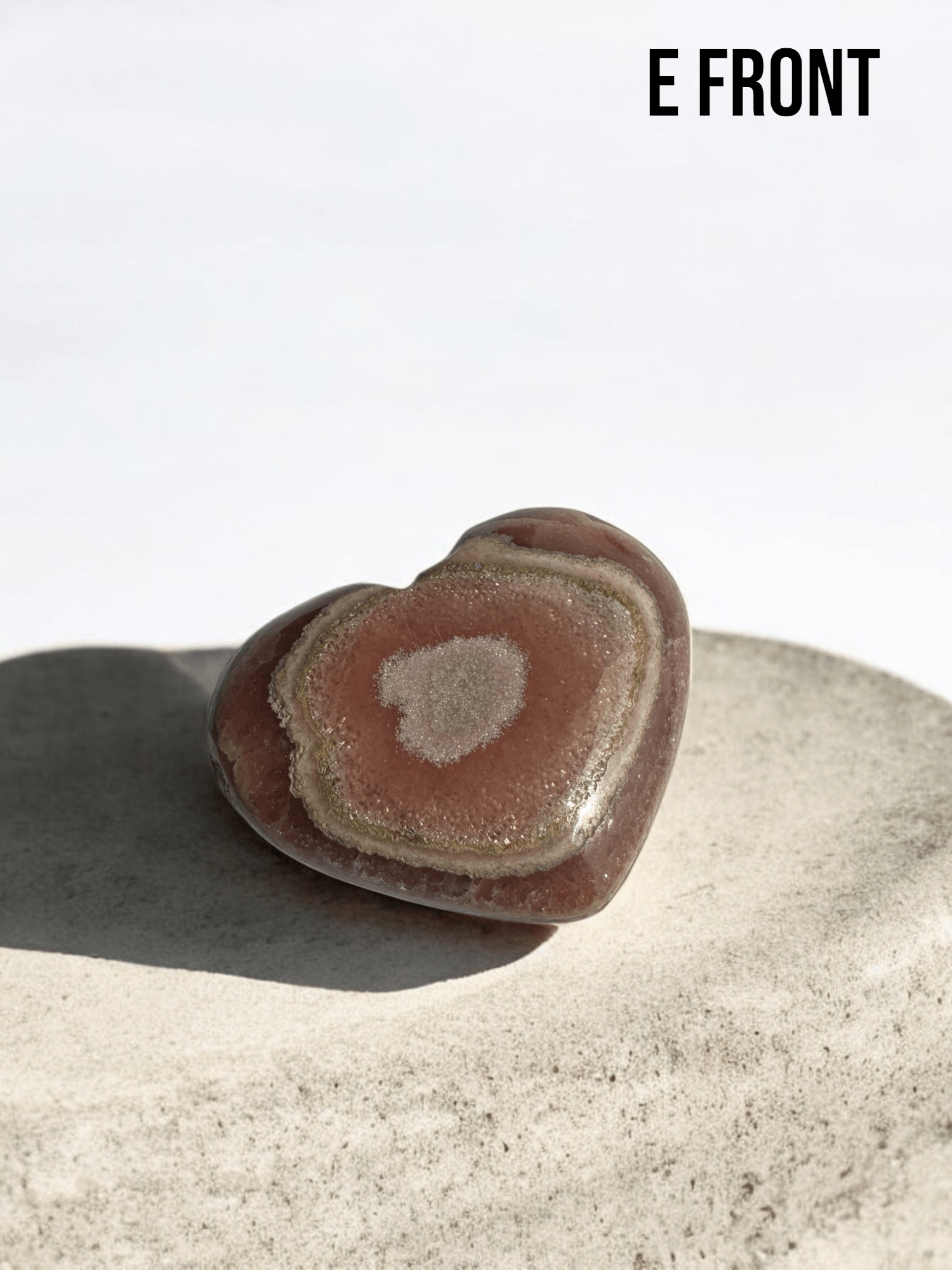 Pink Rhodochrosite heart carved into a crystal shape