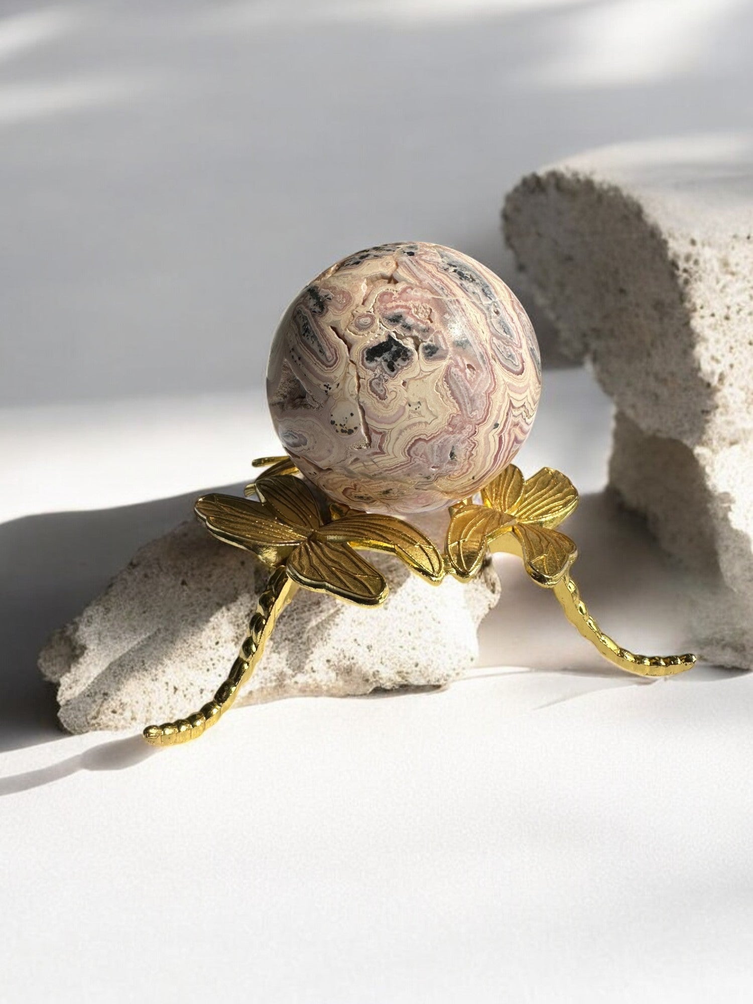 Polished Rhodochrosite sphere showcasing natural patterns