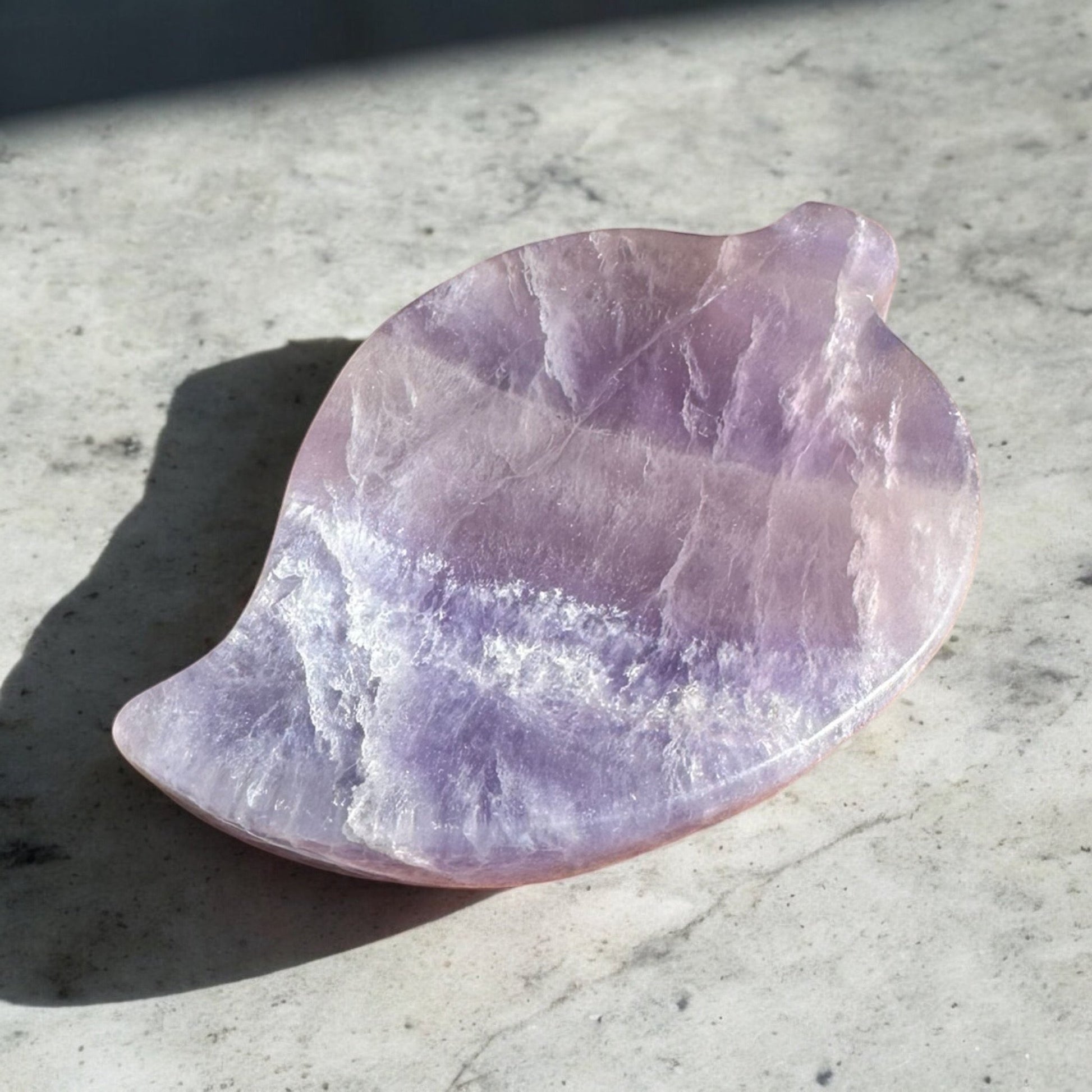 Purple fluorite crystal bowl leaf shape on a counter