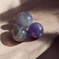 Purple fluorite mini crystal spheres on concrete