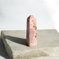 Rhodochrosite crystal tower with brown inclusions