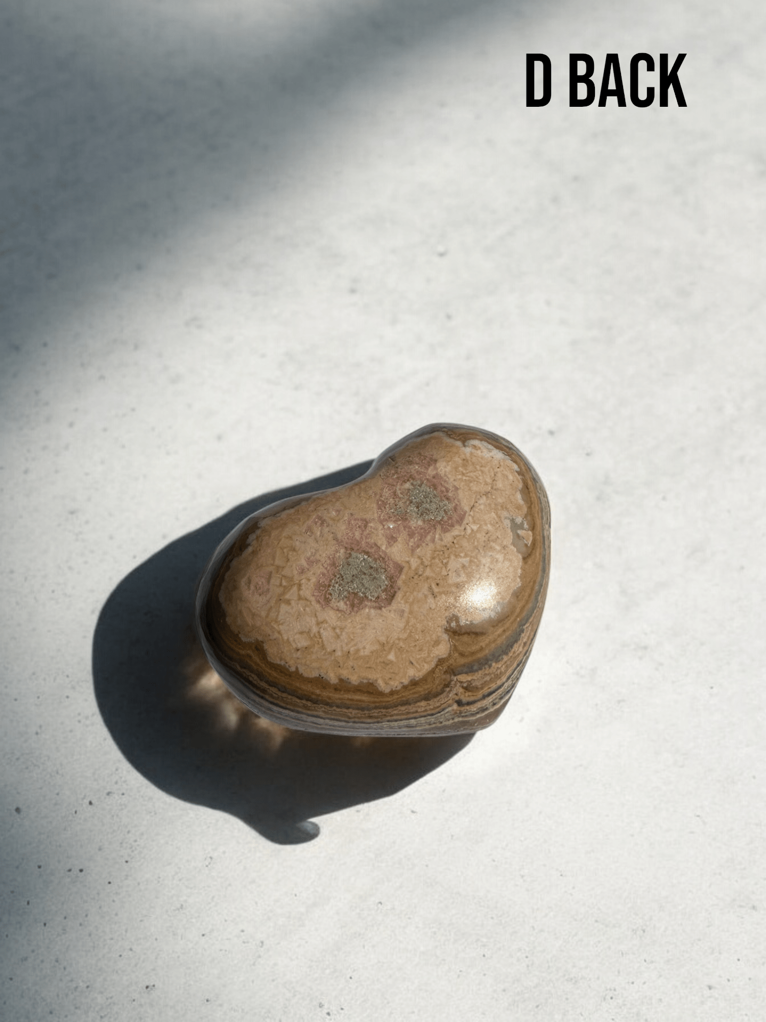 Rhodochrosite heart displaying its natural swirls of color