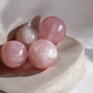 Rose quartz mini crystal spheres on concrete