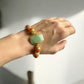 Wearing a Amazonite, Imperial Jasper, Agate, and Pearl Crystal Bracelet