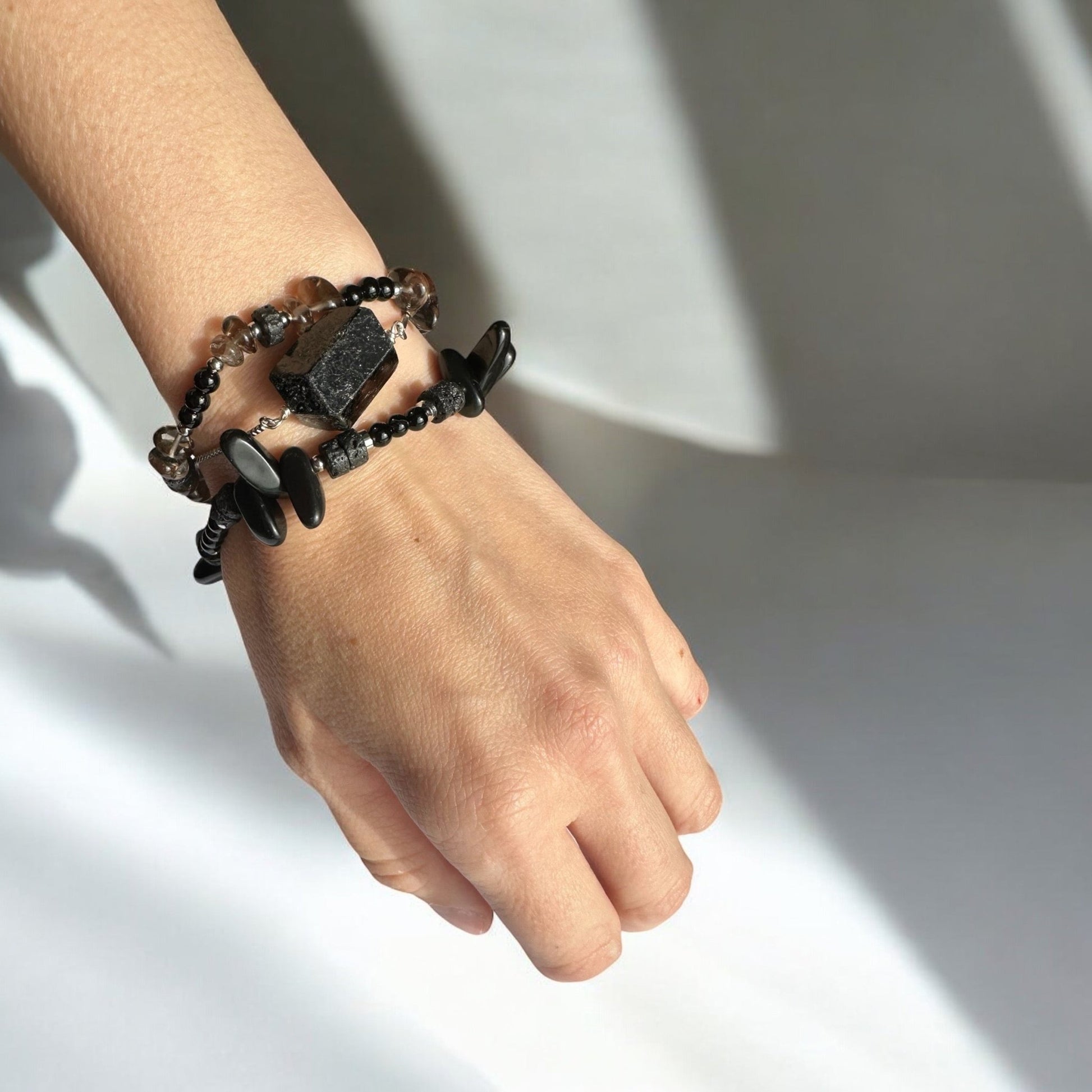 Wearing a Black Onyx, Black Tourmaline, Lava Stone, and Smoky Quartz Crystal bracelet set