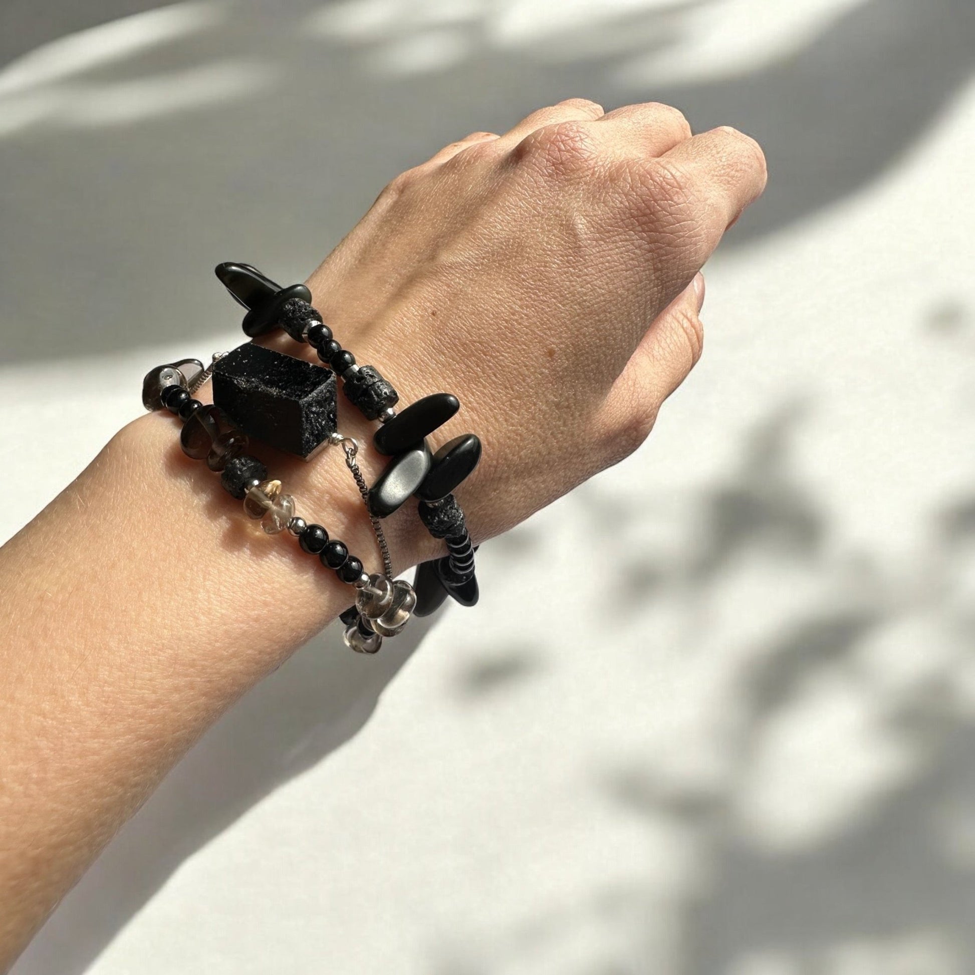 Wearing a Black Onyx, Black Tourmaline, Lava Stone, and Smoky Quartz Crystal gemstone set