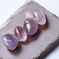 Amethyst tumbled crystals on a slab
