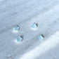 Aquamarine mini crystal stars on concrete