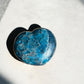 Blue apatite crystal heart in sunlight