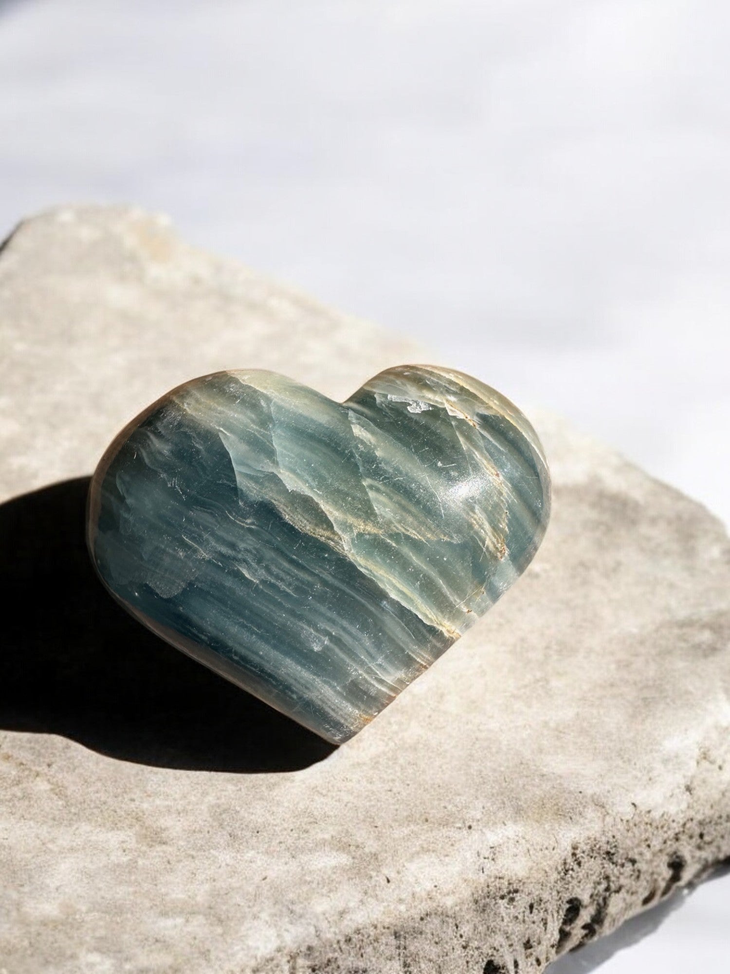 Blue onyx crystal heart on a slab