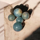Blue onyx crystal spheres on a concrete
