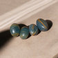 Blue onyx tumbled stones on a concrete