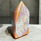carnelian crystal tower with amethyst inclusion
