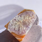Carnelian crystal tower with amethyst and quartz inclusions on a slab