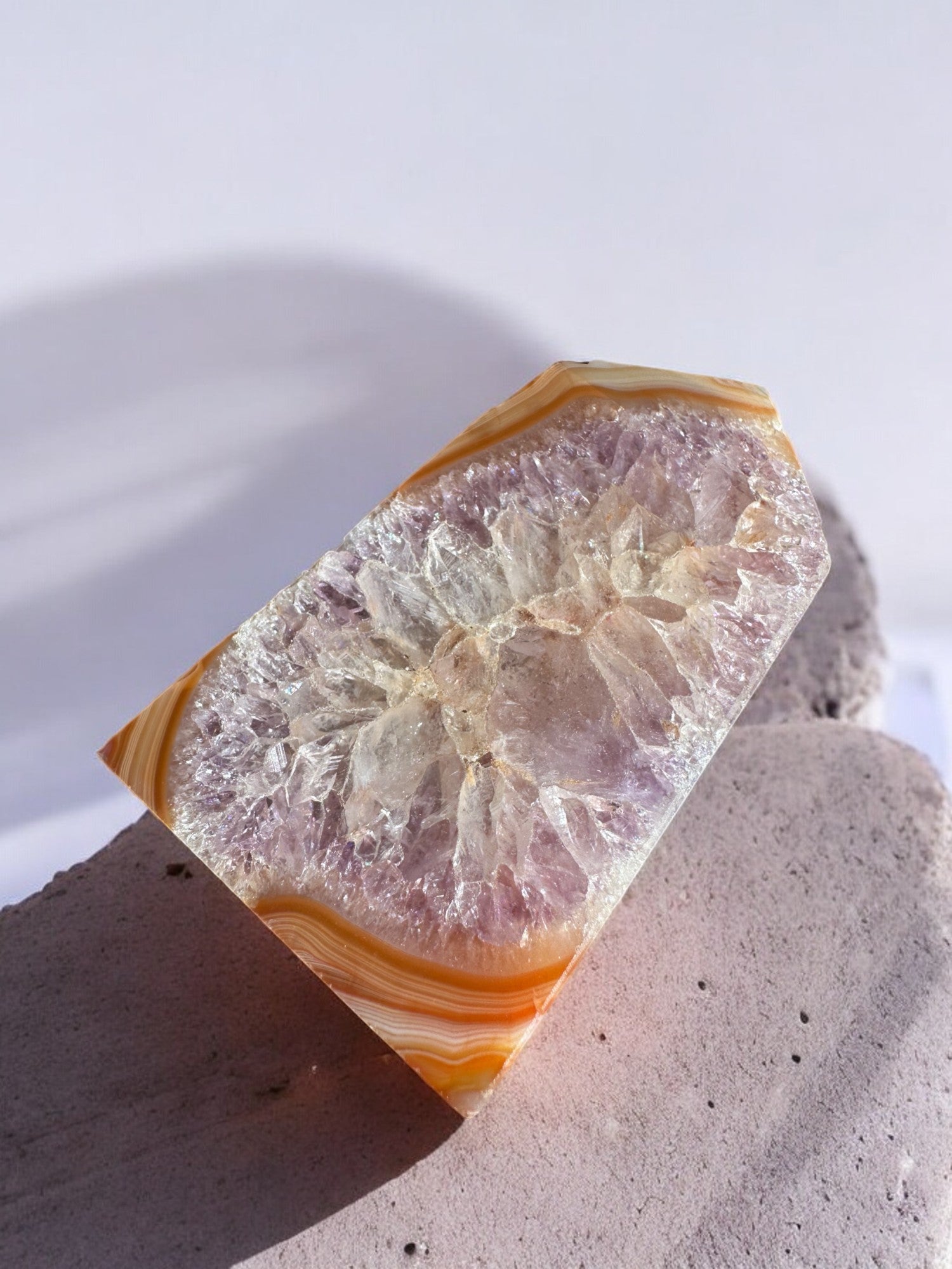 Carnelian crystal tower with amethyst and quartz inclusions on a slab