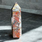 Crazy lace agate crystal tower option ML4 on a concrete with lots of iron