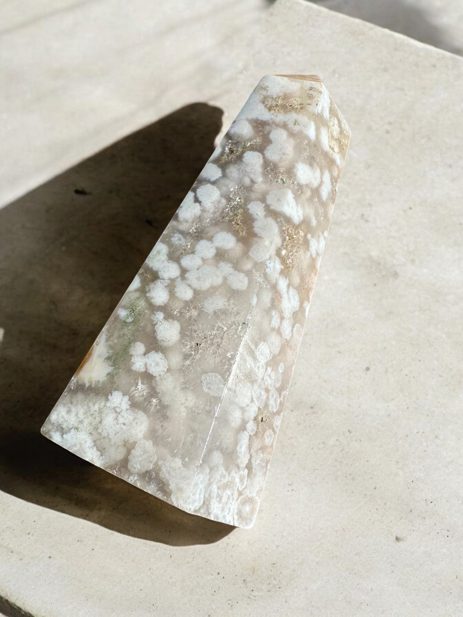 Flower agate crystal tower on concrete