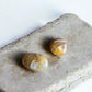 Golden healer quartz palm stones on a slab