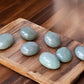 Green aventurine palm stones on slab