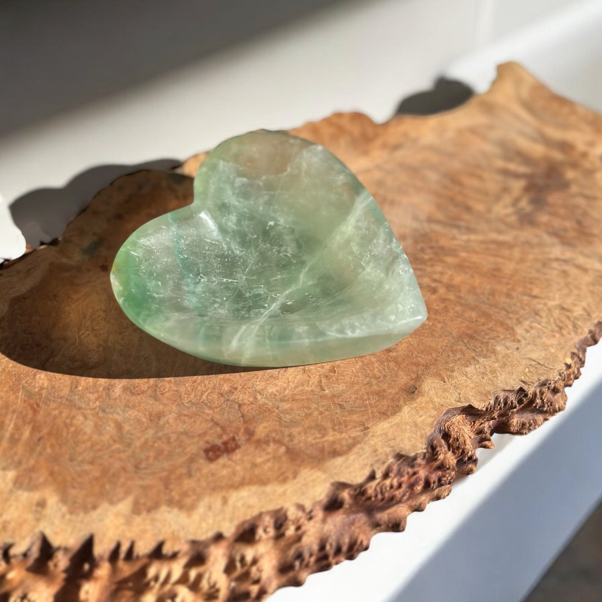 Green fluorite crystal bowl heart shaped on a slab
